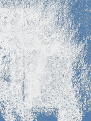 White paint splashing on blue wall creating textured background