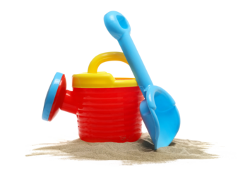 plastic garden toy for kids, watering can and shovel in sand isolated on white background, side view