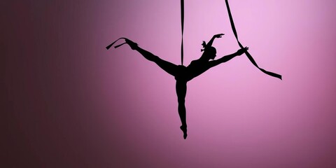 Silhouette of a graceful aerialist in a mid-air split, suspended by black and white ribbons,  elegance,  flexibility