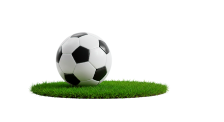 A soccer ball resting on a patch of green grass against a stark black background in a studio shot