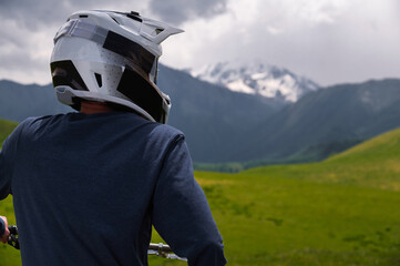 Man riding mountain bike, standing on mountain trail. Man on bicycle in Dolomite Alps landscape....