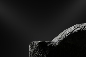 monochrome close-up reveals a portion of a rough-textured, dark-grey rock formation against a subtly illuminated, dark background; the rock's surface displays intricate grooves and shadows