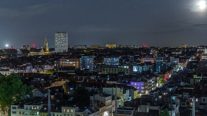 Aerial night timelapse panorama over Brussels skyline in Schaerbeek with Saint-Servais Church