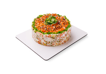 Delicious layered sushi cake with salmon and vegetables on a white plate