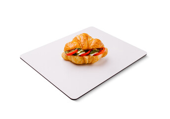 Freshly baked croissant filled with vegetables on a clean surface