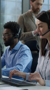 Multinational call center office conflict angry displeased Caucasian male supervisor scolds callcenter female operator African business man Indian woman working support headset tension stress problems