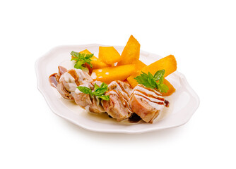 Savory grilled chicken skewers served with fresh mango slices and herbs