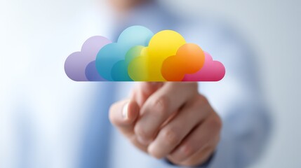 A close-up of a hand touching a colorful cloud icon representing digital innovation.