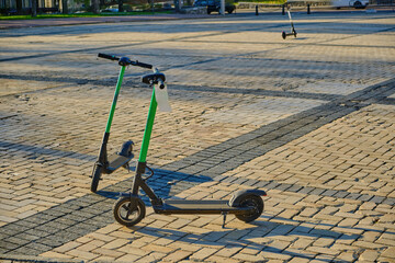 Two Electric Scooters Parked in a City Square