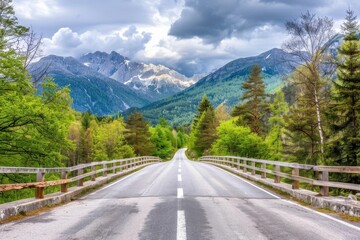 Winding road through lush green mountains with a tunnel entrance at the edge of the forest