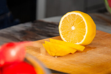 Lemon wedges on a wooden cutting board. Yellow juicy lemon close-up, cut into rings. Food...