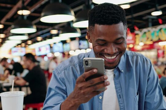 Enjoying time at a vibrant food market while using a smartphone for updates and connections
