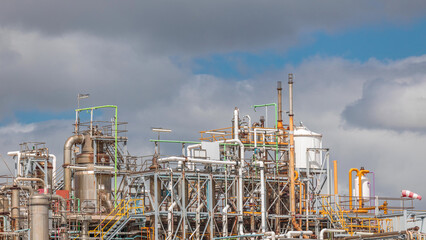 Distillation Columns and their process equipment of hydrogen plant timelapse with clouds on a background.
