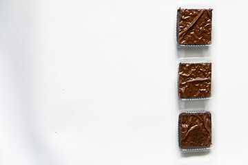 Row of Three Packaged Brownies on White