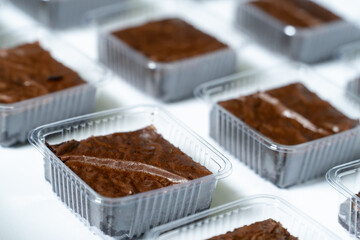 Grid of Individual Chocolate Brownies in Plastic Containers