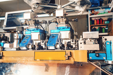 Machine for sewing the toe area of socks. Front view. Textile industry, automatic knitting of socks.