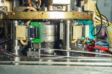 Part of sock knitting machine in operation. Dust from threads. Equipment in textile production.