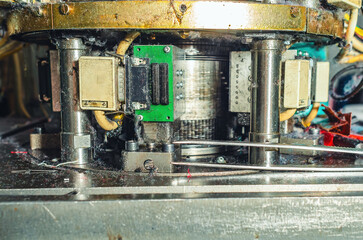 Part of sock knitting machine in operation. Dust from threads. Equipment in textile production.