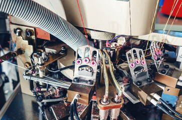 Exhaust pipe on industrial knitting machine. Close-up. Mechanisms of knitting factory. Production...