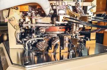 Dust from threads. Image of sock knitting machine in operation. Equipment in textile production.