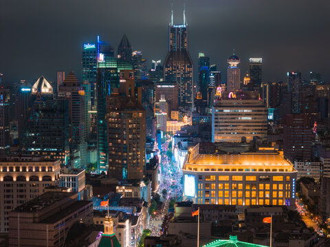 Shanghai, China - 21 June 2025: Aerial view of the Bund's historic architecture and Lujiazui's modern skyscrapers, glowing with vibrant lights against the dark sky.