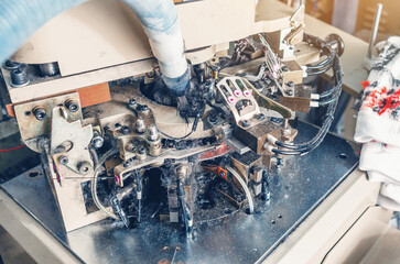 Part of sock knitting machine in operation. Dust from threads. Equipment in textile production.