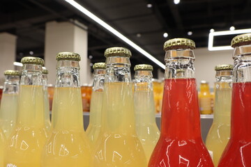 An array of stunningly colorful bottled beverages beautifully showcased on display shelves