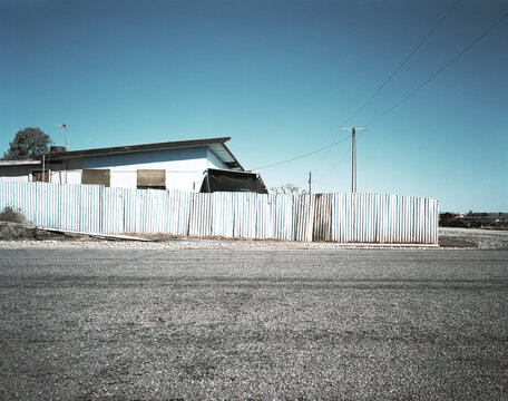 House with metal fence in outback town
