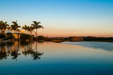 Obraz premium Rural landscape with infinity pool, palm trees and lake