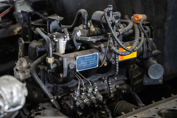 Diesel tractor engine repair process fuel system, wiring and metal components. Agriculture machinery service, automotive diagnostics, mechanical engineering and heavy equipment maintenance concept.