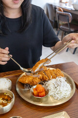 He's dipping pork cutlet in the sauce 돈까스를 소스에 찍고 있는 모습