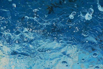 Clear blue water splash with bubbles summer background