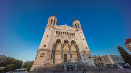 Naklejka premium Hyperlapse front view of the Basilica of Notre Dame de Fourviere during sunset in Lyon, France.