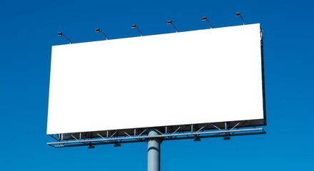 Obraz premium Empty billboard with white surface against a clear blue sky. Blank outdoor advertisement space for mockup or commercial use.
