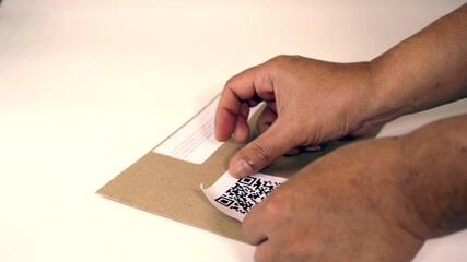 An attaching dummy qr code label to brown envelope modern and efficient method for communication and organization with precision and care