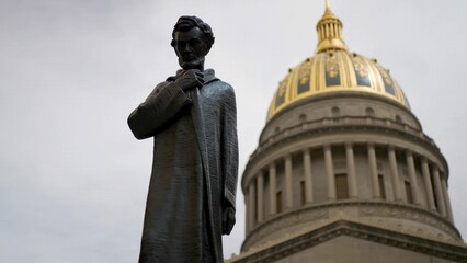 Fototapeta premium A historic statue of Abraham Lincoln stands proudly in front of the West Virginia State Capitol in Charleston. This iconic site attracts many visitors daily.
