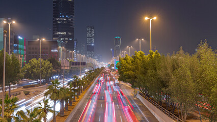 Aerial timelapse view of busy highway traffic on King Fahd Road with the iconic twisting skyscraper in Riyadh, Saudi Arabia