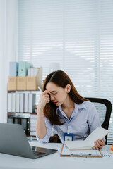 Asian businesswoman or female office worker who is angry, irritated, stressed over a failed job. and crumpled documents in her hands at her desk. Depression overworked Office Syndrome.