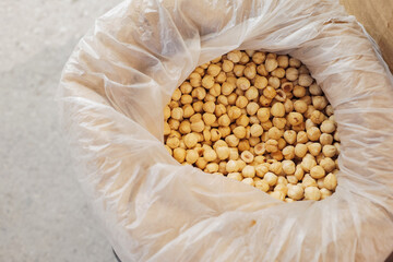 Freshly harvested chickpeas in a clean bag at a local market during daylight hours
