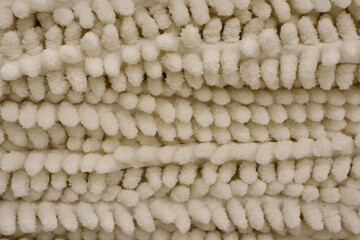 This is a Textured Creamy Fabric that is complemented by Soft PomPom Elements, adding elegance