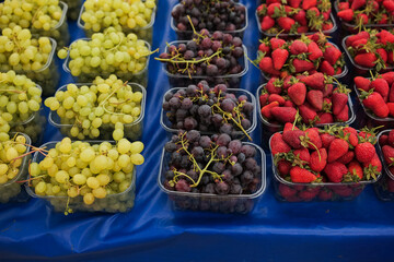 Fresh fruits displayed in baskets at a vibrant market stall during morning hours