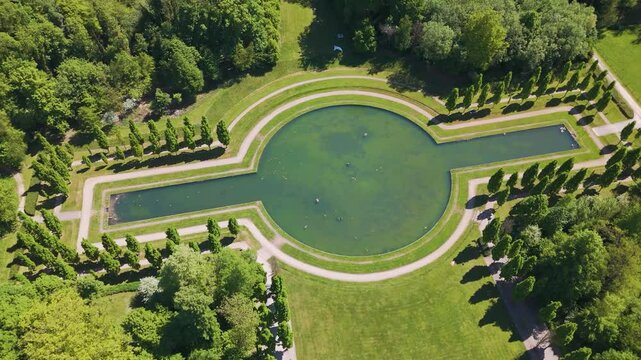 ch&acirc;teau seneffe large water filled pond offering complete sun reflecting surrounding green parks revealing backside circles aerial view of de belgium 