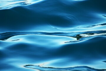 Blue wave surface with shine and reflection water background