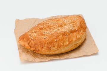 Brazilian pastry packed in brown paper on a white background