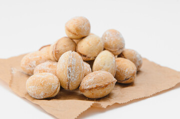 Delicious nut shaped cookies with boiled condensed milk on white background
