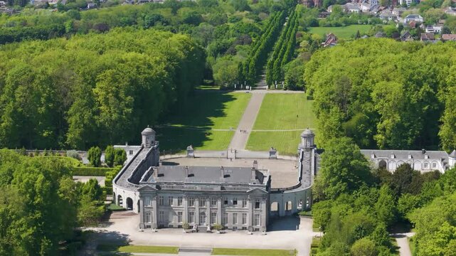 main part ch&acirc;teau seneffe green parks behind visitors walking toward building create lively scene left to right front pans aerial drone of de belgium 