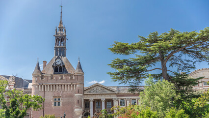 Fototapeta premium Renaissance dungeon clock tower and classical brick facade of the Capitole timelapse hyperlapse, city hall of Toulouse, France