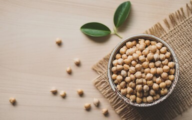Rustic bowl of chickpeas with green leaves burlap