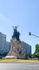 Majestic bronze monument rises with defiant grace amid urban hustle, embodying resistance on...