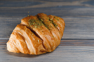 fresh croissant on a wooden background